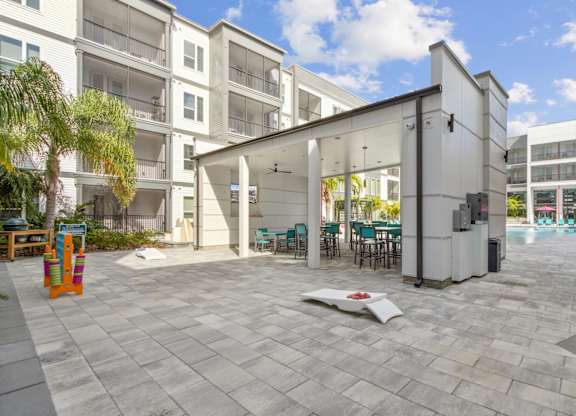 A white building with a patio area in front at Pinnacle Apartments, Jacksonville, FL