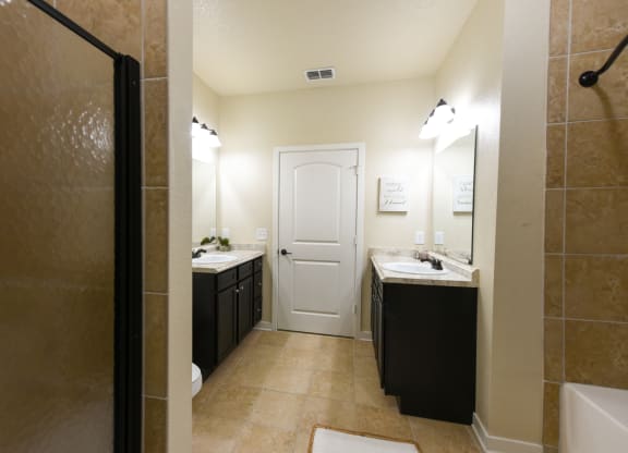a bathroom with a shower sink and toilet and a sink and a mirror at Hacienda Club, Florida