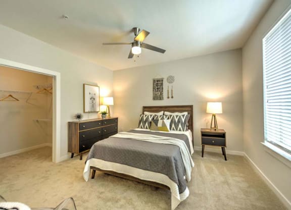 a bedroom with a bed and a ceiling fan  at Luxor Club, Jacksonville, 32258
