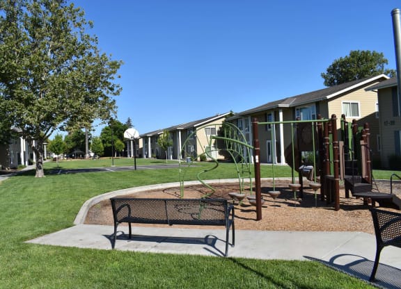 Mutual Housing on the Greenway bench near playground