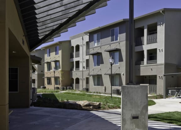 New Harmony Mutual Housing Community building exterior, shaded area outside community room/leasing office