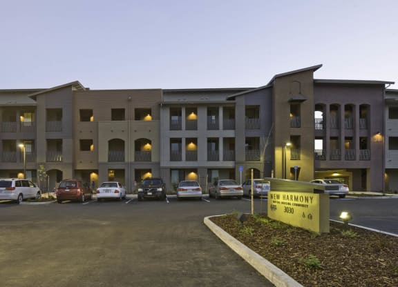New Harmony Mutual Housing Community building exterior, parking lot, community sign