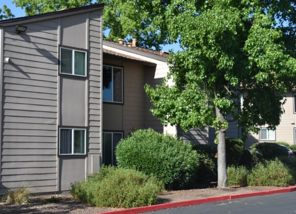 Mutual Housing at Foothill Farms unit exteriors facing trees, shrubs, parking lot