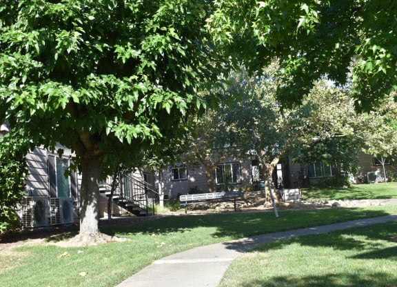 Mutual Housing at Foothill Farms sidewalk surrounded by trees and grass