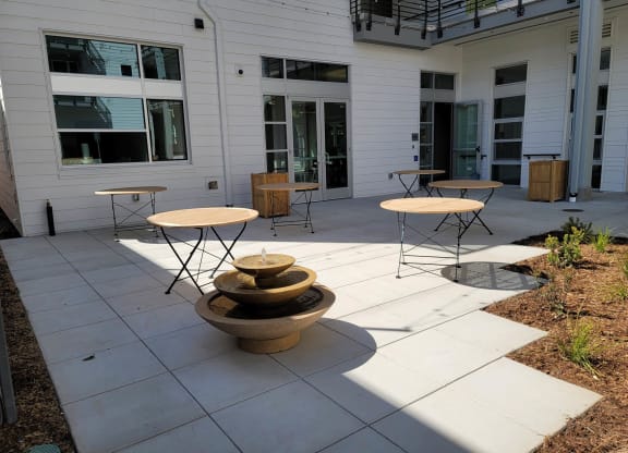 Seating / picnic area with tables and chairs and small fountain.
