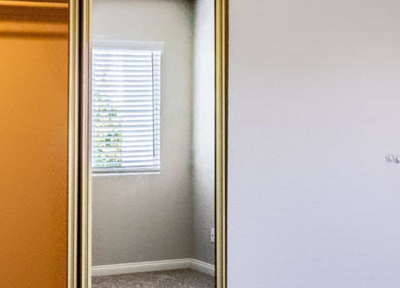 a mirror with a reflection of a window and a door