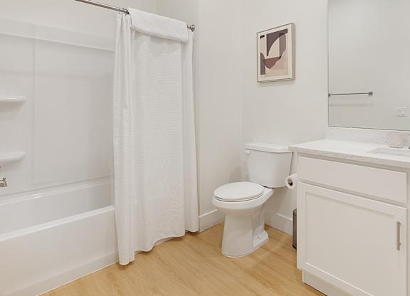 A white bathroom with a toilet, sink, and bathtub.at Aerie La Cholla, Tucson, 85741