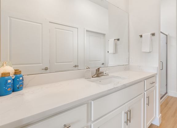 A white bathroom with a sink and mirror.at Aerie La Cholla, Arizona, 85741