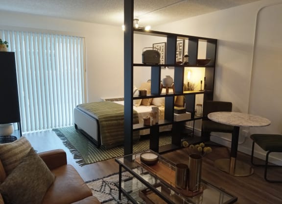 a living room with a couch and a table and a bed