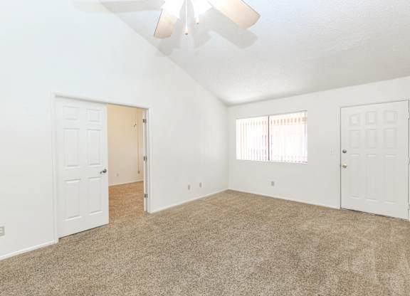 A room with white walls and a carpeted floor.