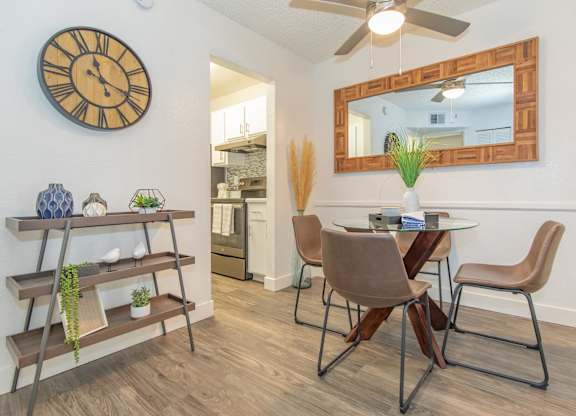 A dining room with a table and chairs.