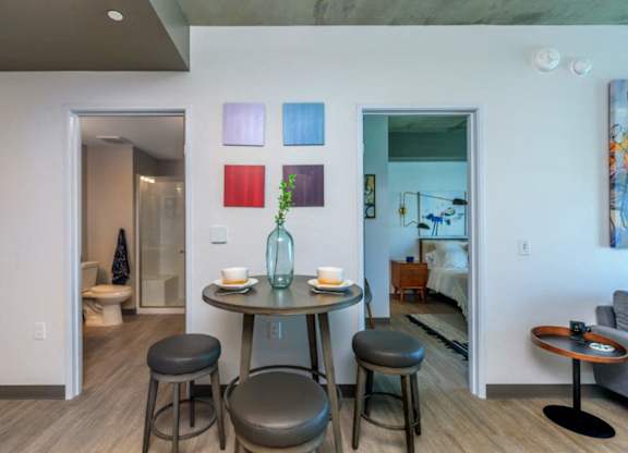 A dining area with a table and chairs.