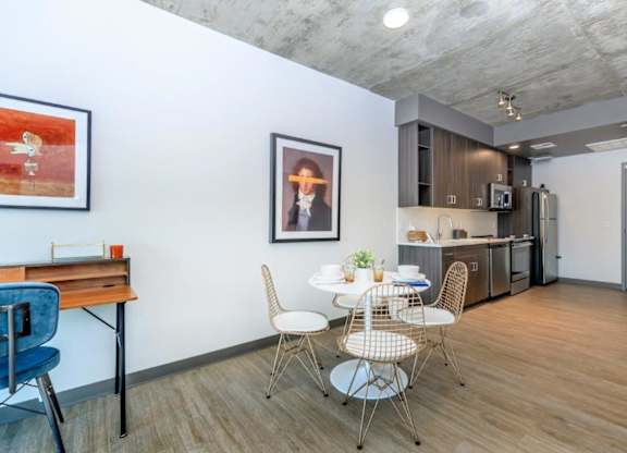 A dining area with a white table and chairs.