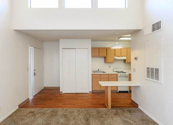 A kitchen with white cabinets and a wooden island.
