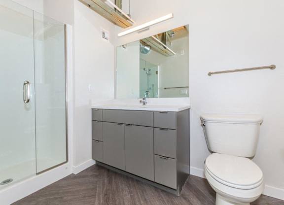 A white toilet sits next to a sink in a modern bathroom.