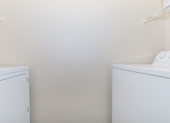 A white cabinet and a white sink in a room.