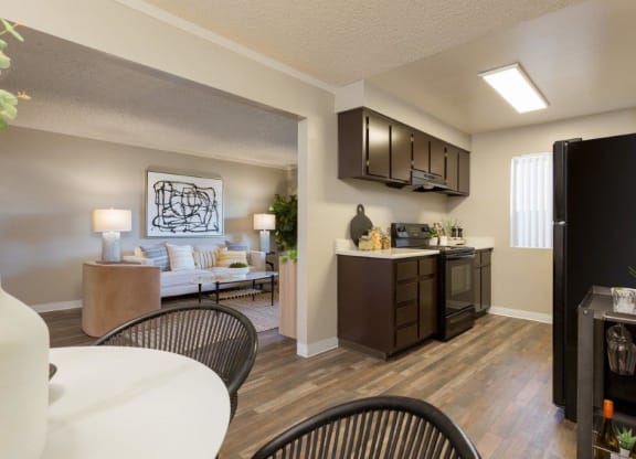 a kitchen and living room with a table and chairs