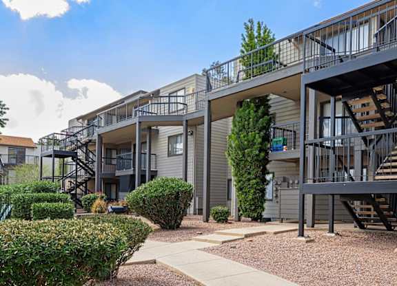Apartment complex with a walkway between the buildings.