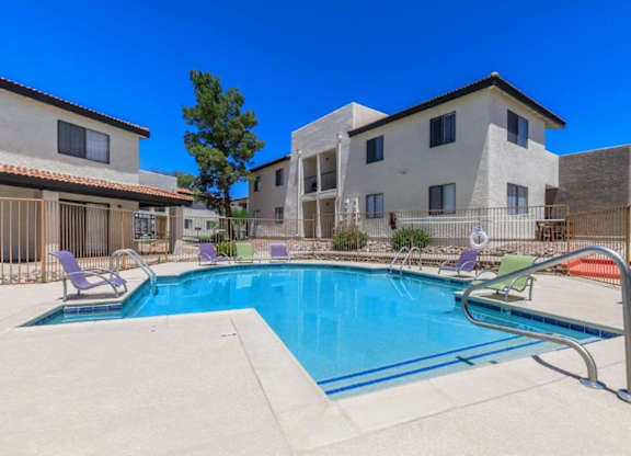 A swimming pool in front of a residential building.