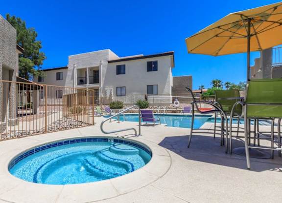 A small round pool with a metal fence around it.