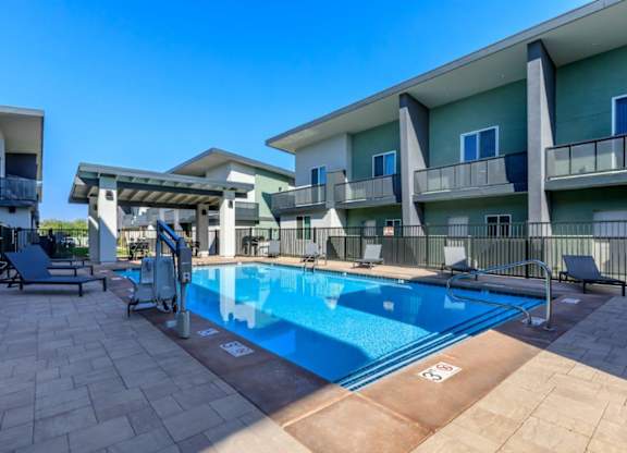 The Hedrick on Mountain Townhome-Style Apartments in Tucson, Arizona Pool with Lounge Chairs