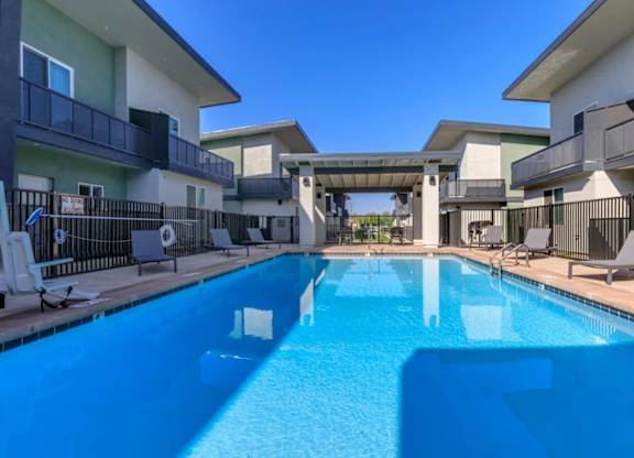 The Hedrick on Mountain Townhome-Style Apartments in Tucson, Arizona Pool with Lounge Chairs