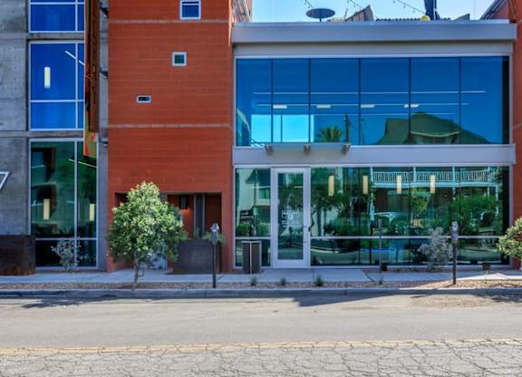 A building with a red brick facade and large glass windows.