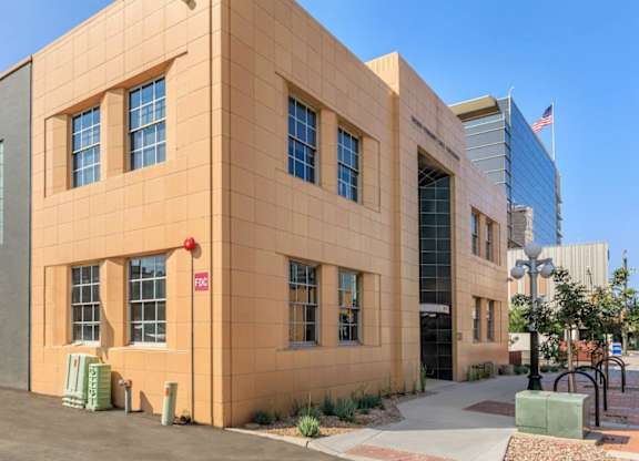 A building with a red sign on the left side of it.