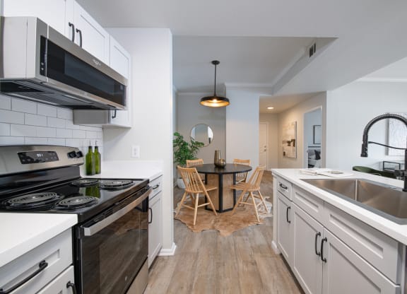 a kitchen and dining area in a 555 waverly unit