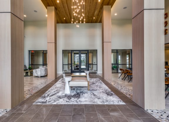 a large lobby with a seating area and a chandelier