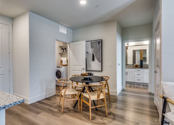 a dining room with a table and chairs and a laundry room