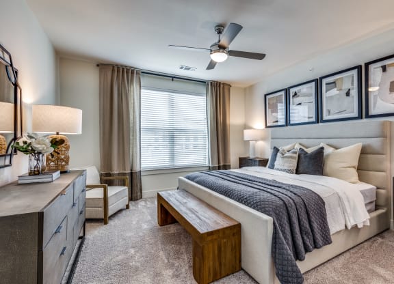a bedroom with a large bed and a ceiling fan