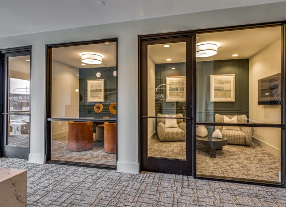 a conference room with large windows and a table and chairs