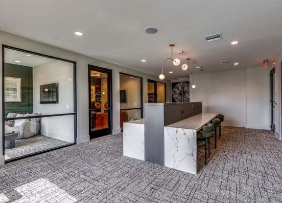 a large lobby with a reception desk and a table with chairs