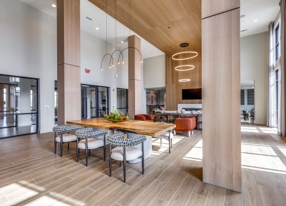 a large dining room with a wooden table and chairs