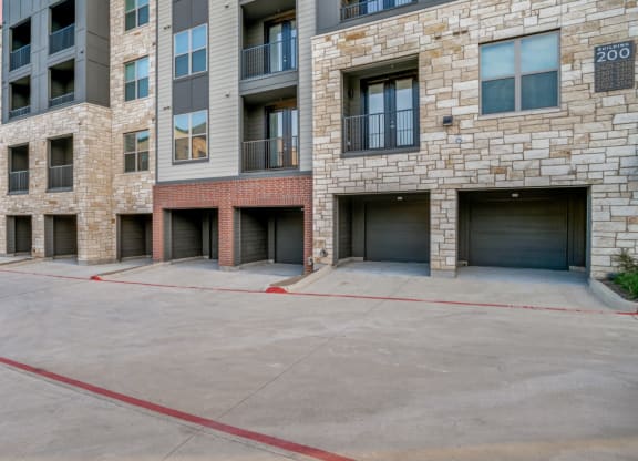 an empty parking lot in front of an apartment building