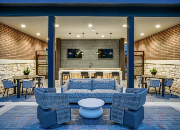 the lobby of a hotel with a couch and tables