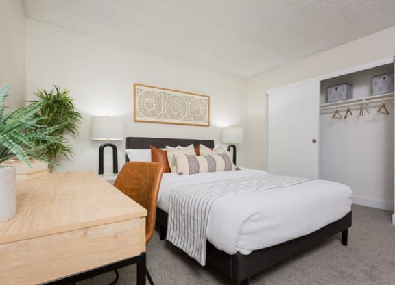 a bedroom with a bed and a table