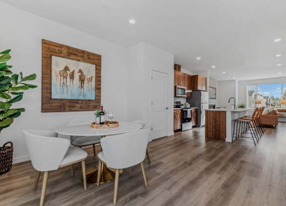 A modern kitchen with a dining table and chairs.