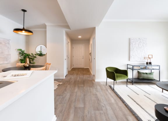 a living area with white walls and hardwood floors
