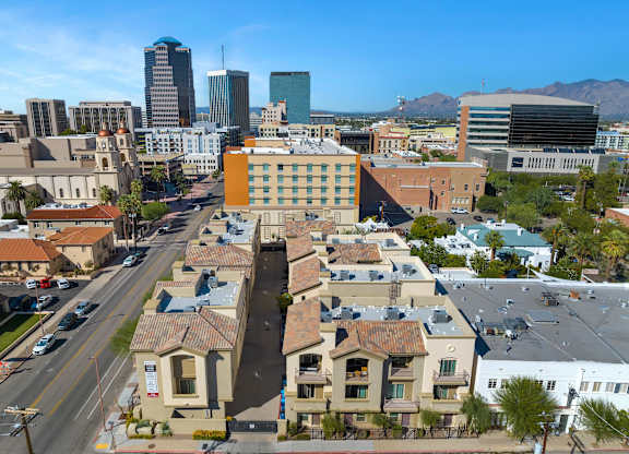 A city street with apartment buildings and cars.