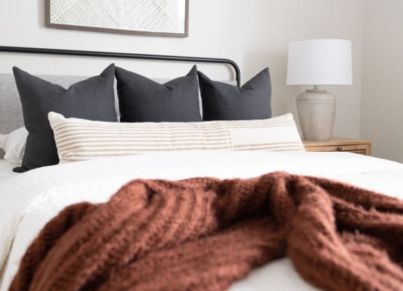 a bed with a red blanket on top of it
