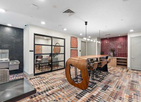 a dining room with a long wooden table and chairs