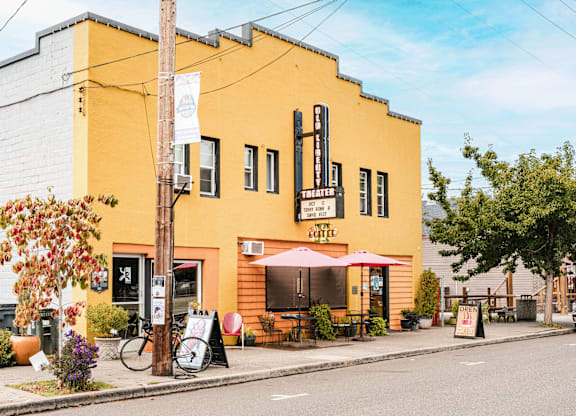 A yellow building with a red umbrella outside.