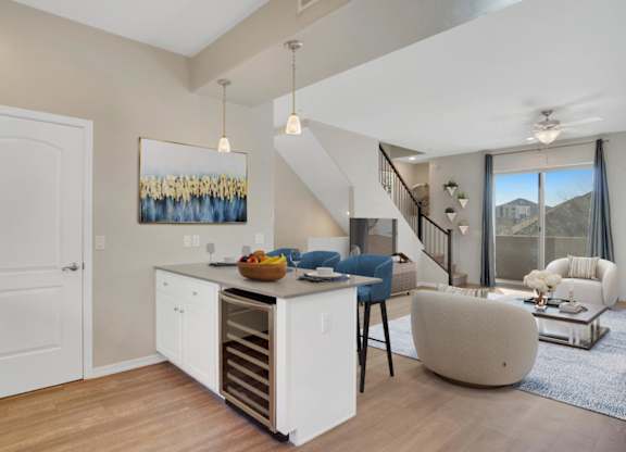 A modern kitchen with a white cabinet and a painting on the wall.