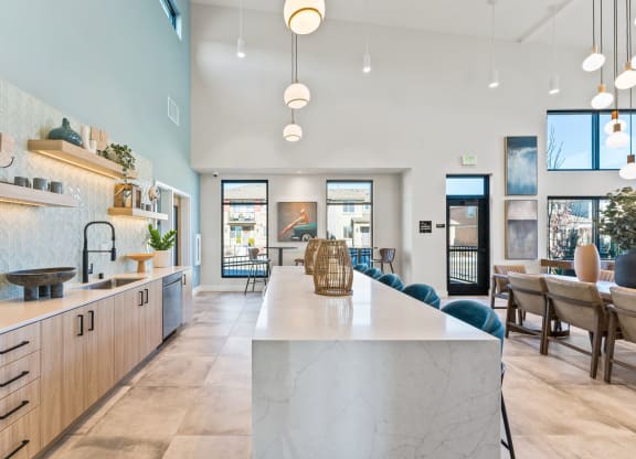 a large kitchen with a marble counter top and a dining room