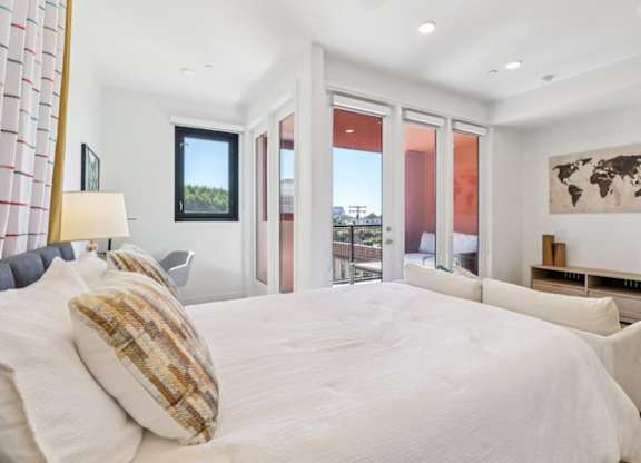 A bedroom with a large bed and a world map on the wall.