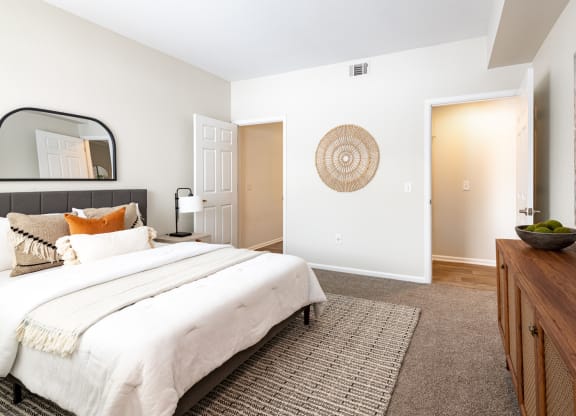 a bedroom with a large bed and a dresser
