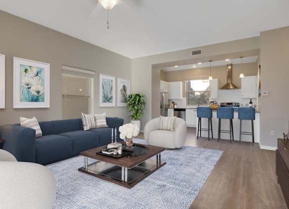 A living room with a blue couch and a coffee table.