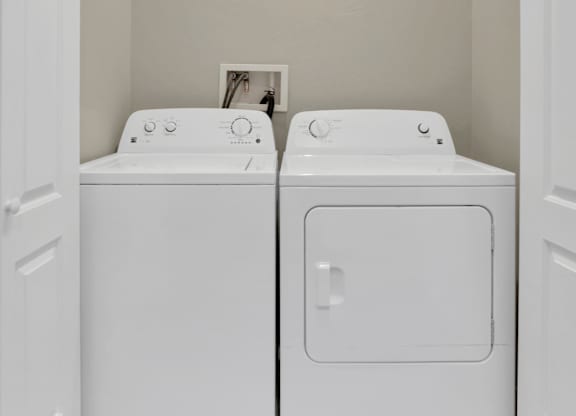 A small laundry room with two washing machines.